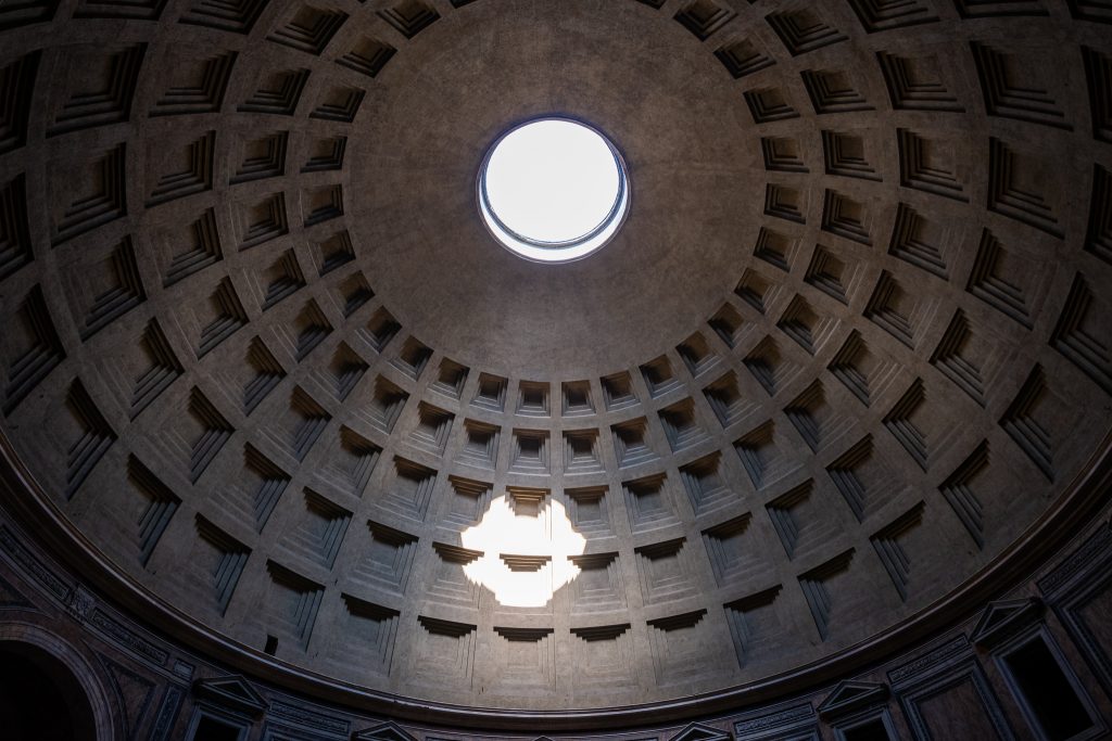 Color photo looking straight up at the Pantheon's coffered concrete dome and open circular oculus, Rome.